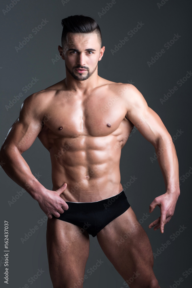 muscular man with muscle torso in studio, sport and training