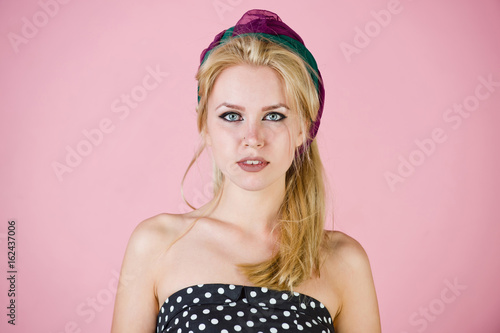 pretty sexy woman with turban and makeup on pink, pinup