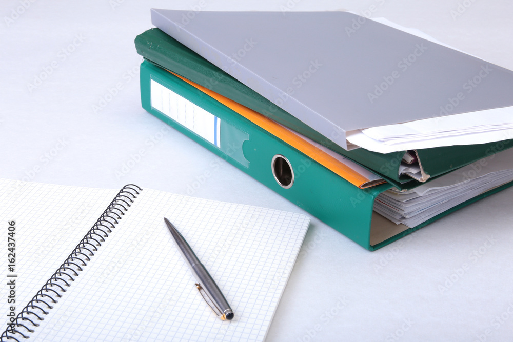 Folder file, note and pen on the desk. blurred background. Folder file, note and pen on the desk. blurred background.