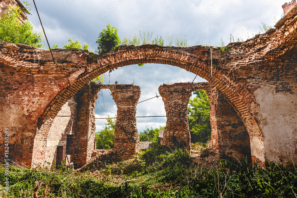 Ruins of an ancient abandoned Orthodox temple or church of red brick with big Arches 