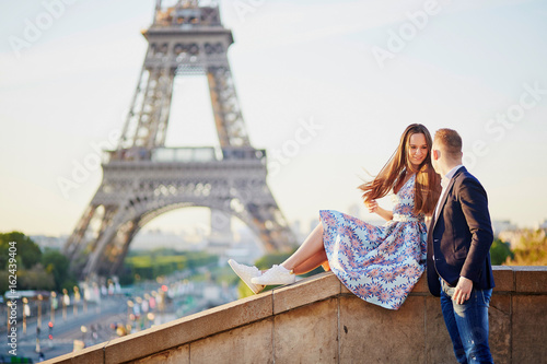 Beautiful loving couple sitting near the Eiffel tower in Paris © Ekaterina Pokrovsky