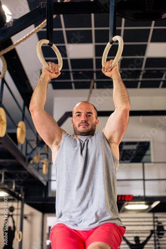 Strong man on gymnastic rings © Jovan