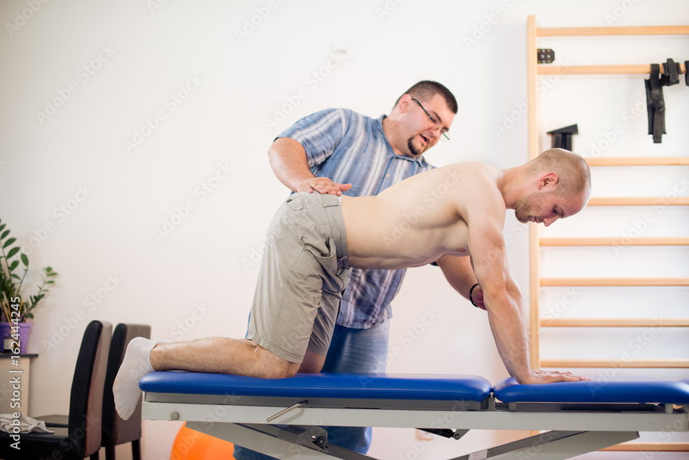 Fototapeta premium Young athlete at physio therapy
