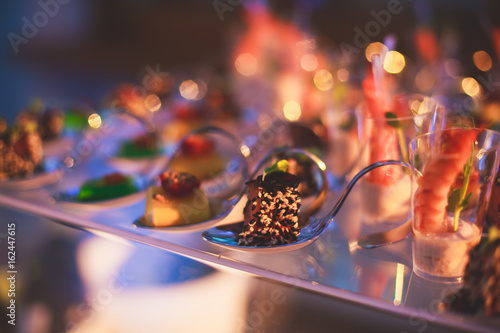 Photographie Decorated catering banquet table with different food appetizers assortment on a