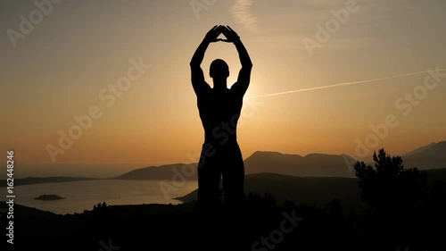 Young man training on sunset
