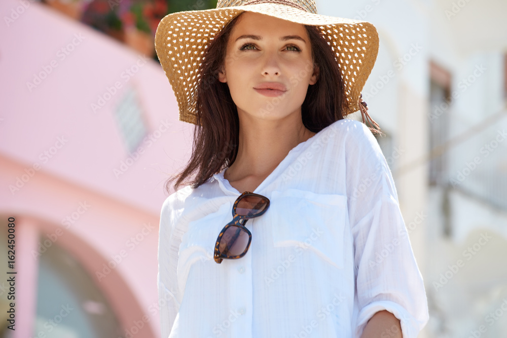 Fototapeta premium Young beautiful woman walking the streets of an Italian town