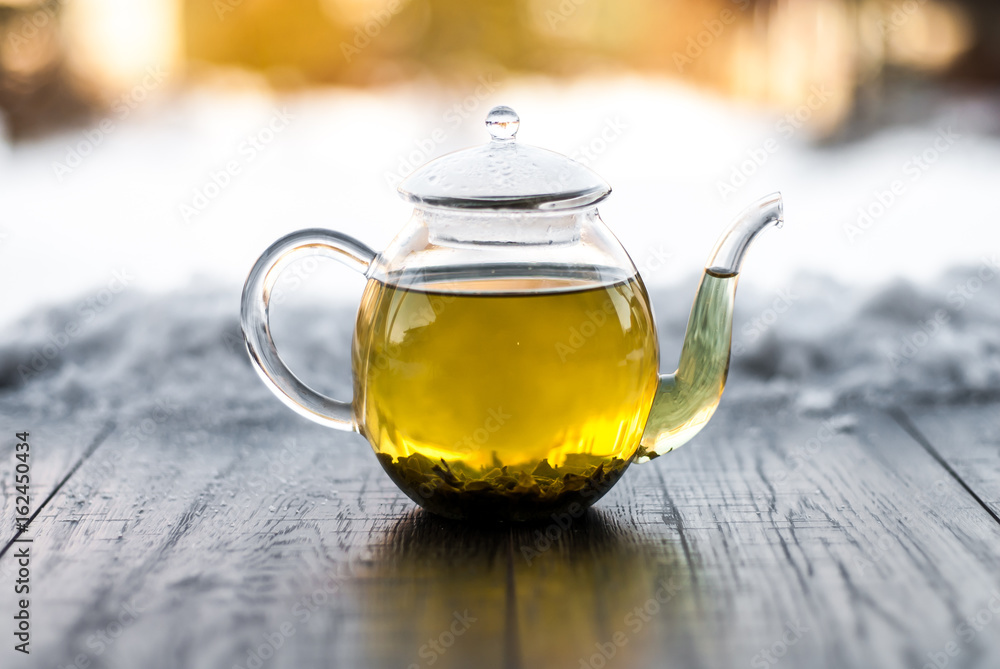 Tea with snow on wooden background table. Tea with snow on wooden background table.