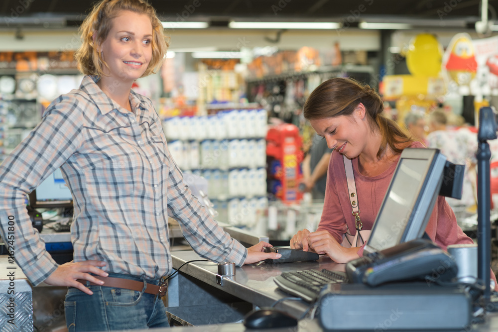 customer paying in harware shop using credit card terminal customer paying in harware shop using credit card terminal