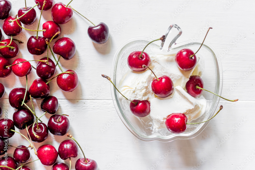 Ice cream decorated with fresh cherry on white table background top view Ice cream decorated with fresh cherry on white table background top view