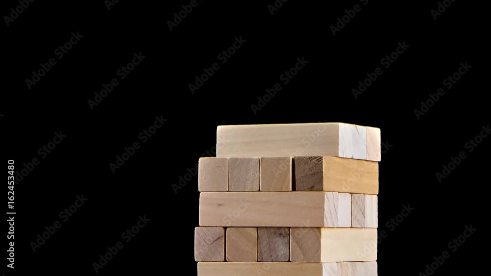 Tower blocks jenga game gather in building. Stop motion, black background