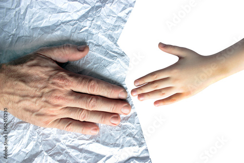 Palms for children and the old man on crumpled paper, a symbol of the future and the past, life from beginning to end