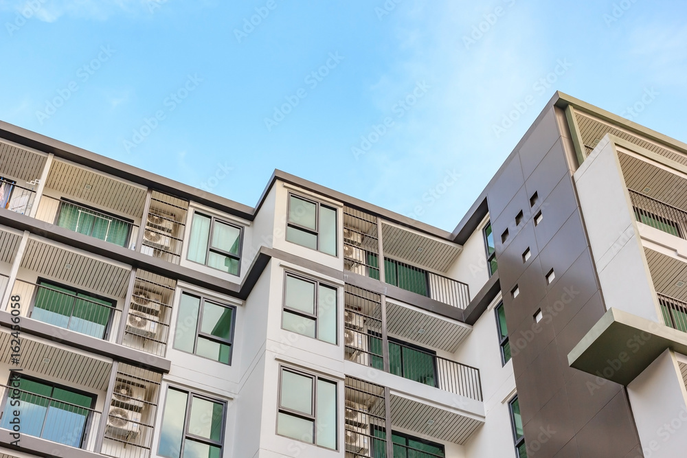 Modern, Luxury Apartment Building against blue sky Modern, Luxury Apartment Building against blue sky