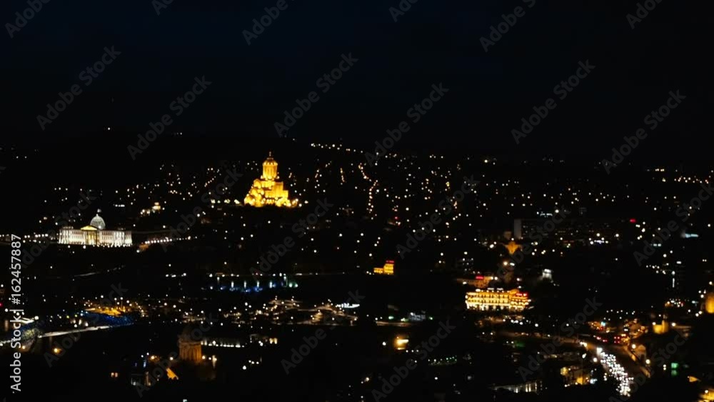 Old night European city view from above. The movement of cars on the road in night. Night light of old town. Old night European city view from above. The movement of cars on the road in night. Night light of old town.