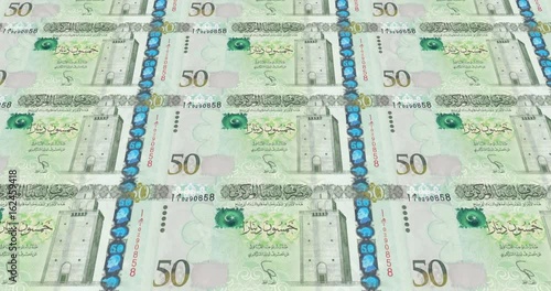 Banknotes of fifty libyan dinars of Libya rolling on screen, cash money, loop