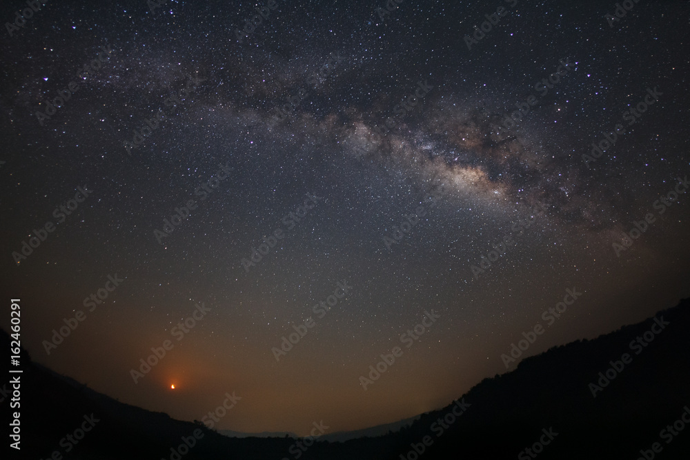 Milky Way and moon light at Phu Hin Rong Kla National Park,Phitsanulok Thailand, Long exposure photograph.with grain