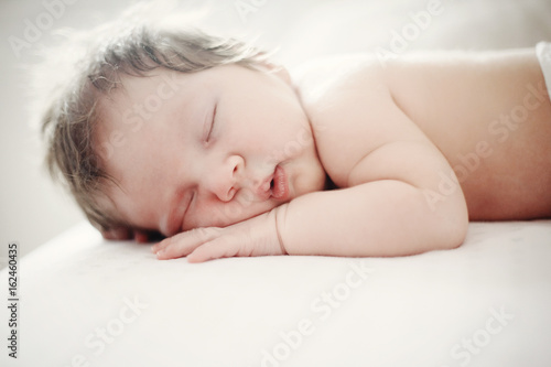 adorable baby sleeping on stomach, close-up