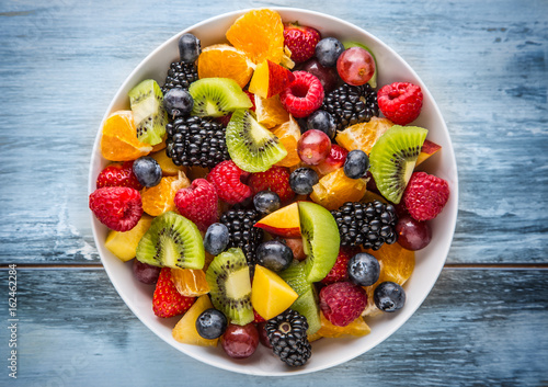 Fruit fresh mixed tropical fruit salad. Bowl of healthy fresh fruit salad - died and fitness concept.