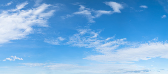Panorama of blue sky background with white clouds on a sunny day