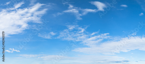 Panorama of blue sky background with white clouds on a sunny day