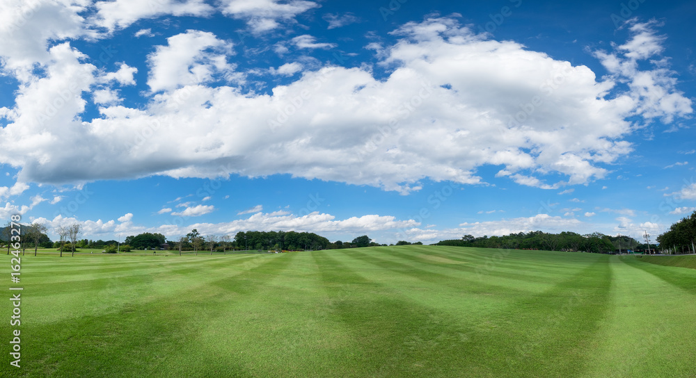 Fototapeta premium Panorama of sky clouds and grass on meadow in summer