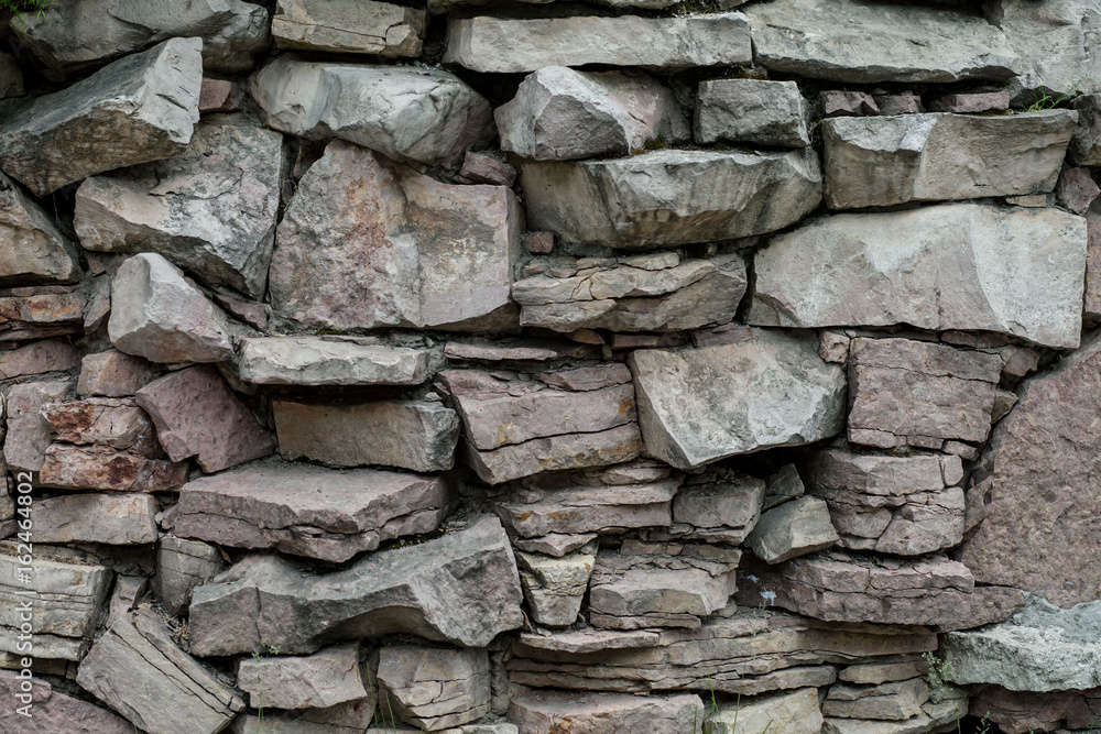 Cracked real stone wall surface Cracked real stone wall surface