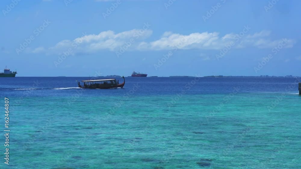 Traditional Maldives style boat sailing for tourist activities in Indian sea Traditional Maldives style boat sailing for tourist activities in Indian sea