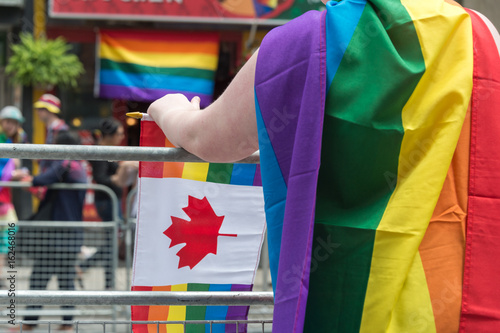 Photography Toronto, CA - 25 June 2017: A girl with rainbow gay flag on her back at Toronto