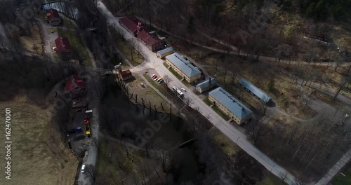 Fiskars village, Cinema 4k aerial view following a car driving through fiskari ironworks, at a spring day, in Raasepori, Uusimaa, Finland photo