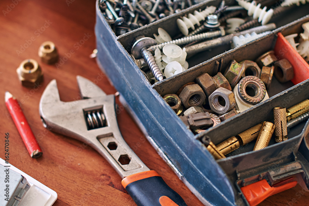Fototapeta premium Used repair kit and adjustable wrench on the table