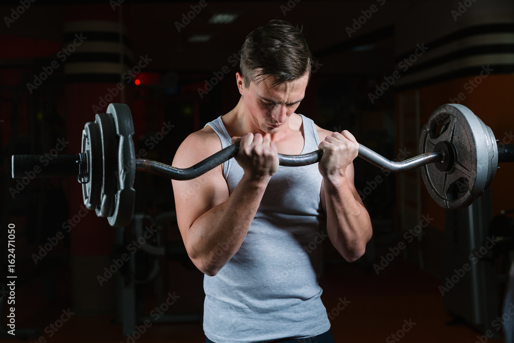 Closeup portrait of a muscular man workout with barbell at gym. Deadlift barbells workout. Closeup portrait of a muscular man workout with barbell at gym. Deadlift barbells workout.