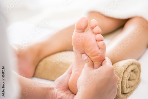 Therapist giving traditional thai foot massage to a woman in spa © Atstock Productions