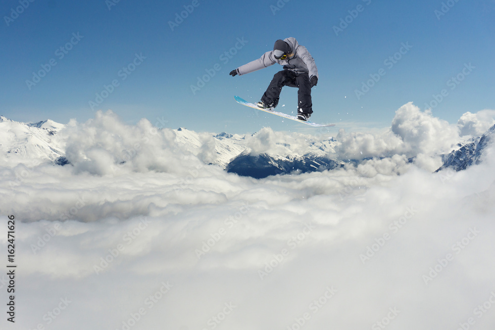 Snowboarder jumping in the mountains. Extreme sport.