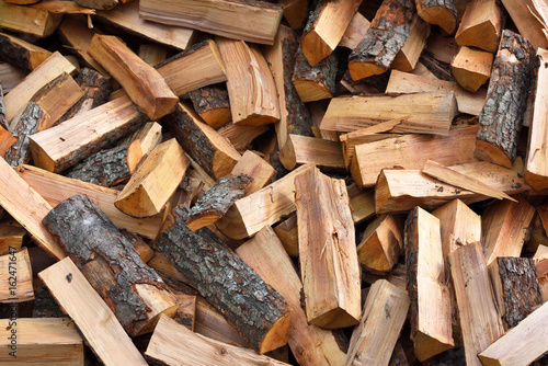 Firewood background - chopped firewood on a stack photo