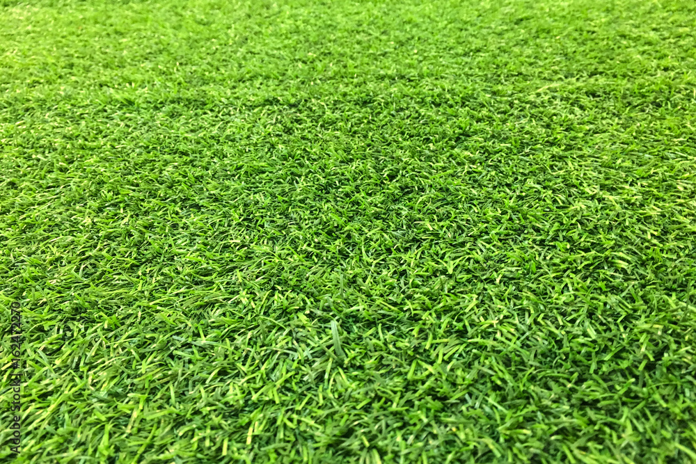 Artificial green grass background, top view Artificial green grass background, top view