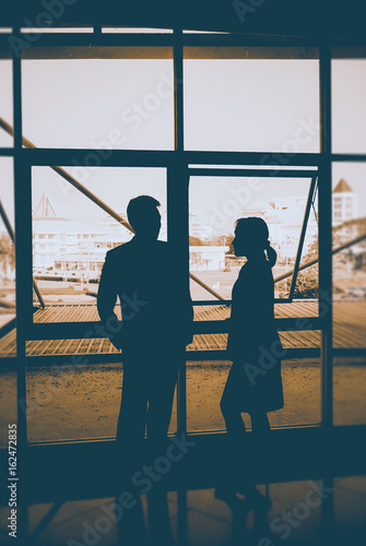 Businessman and businesswoman talking, silhouette