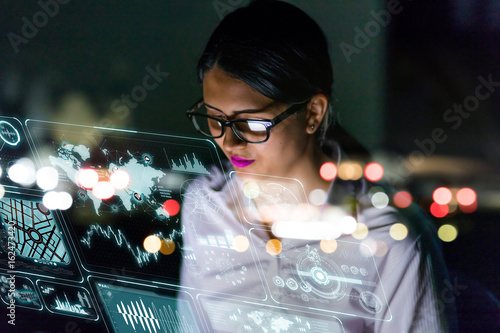 Businesswoman looking at futuristic interface screen photo