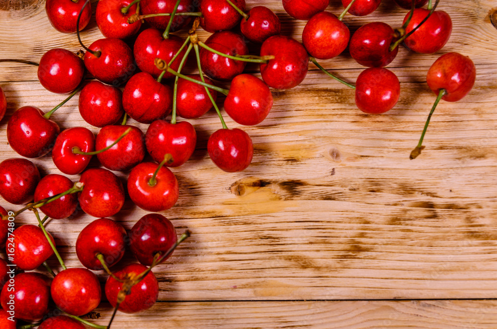 Fresh ripe cherries on wooden table. Top view Fresh ripe cherries on wooden table. Top view