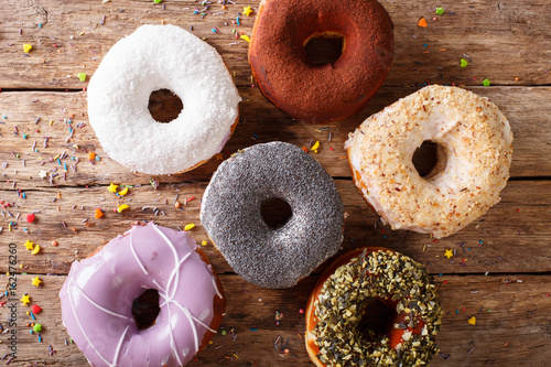 Fresh donuts with frosting close-up on the table. horizontal top view