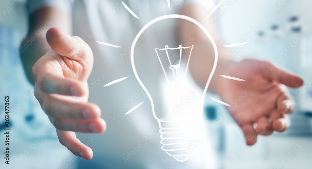 Businessman holding a sketch lightbulb Businessman holding a sketch lightbulb