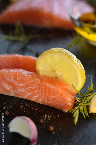 Raw salmon fillets served with lemon