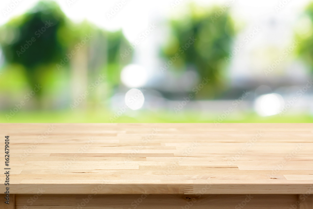 Wood table top on blurred green tree background Wood table top on blurred green tree background