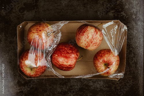 Quadro em tela Apple wrapped in plastic