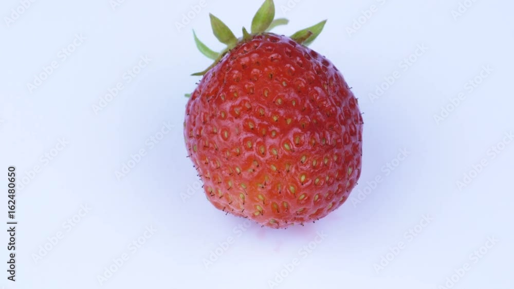 One fresh, juicy strawberry on the plate. Maсro video of a red strawberry rotation. One fresh, juicy strawberry on the plate. Maсro video of a red strawberry rotation.