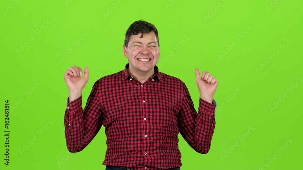 Young guy is happy with his victories, he is happy. Green screen. Slow motion Young guy is happy with his victories, he is happy. Green screen. Slow motion