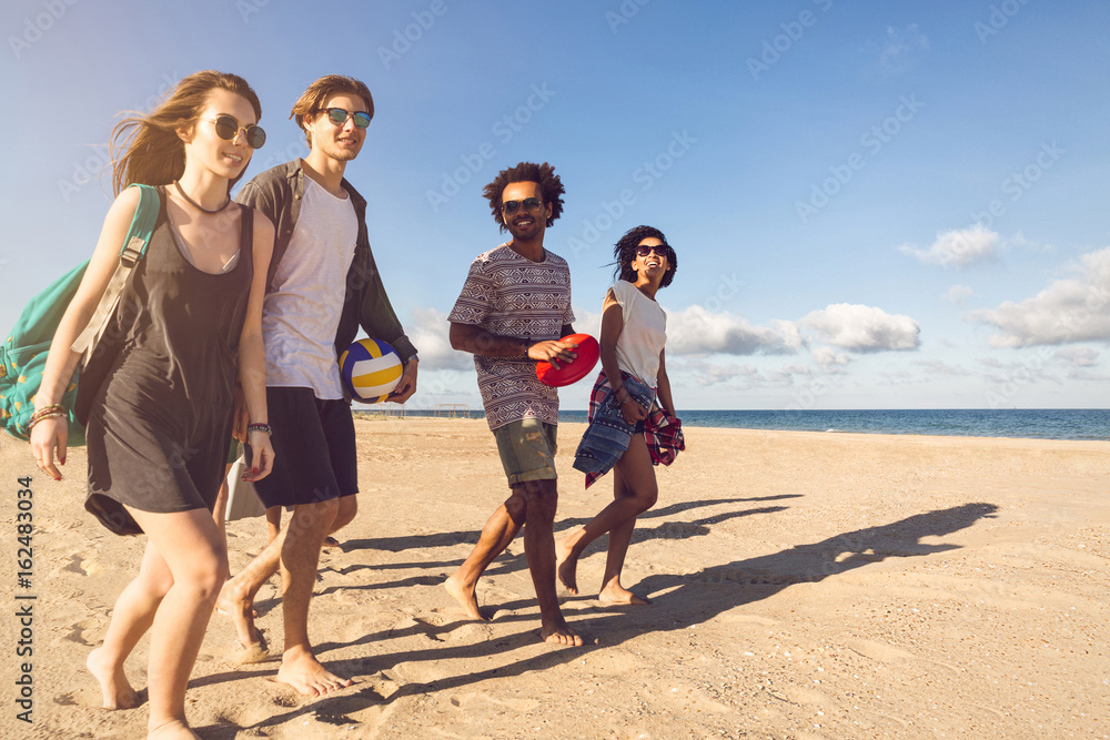 Group of smiling friends in sunglasses