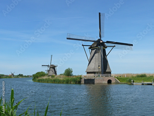 Row of mills in Kinderdijk, Netherlands. This cover nineteen mills in the northwest of the Alblasserwaard, in the Green Heart of Holland. Since 1997 they have been on UNESCO World Heritage List.