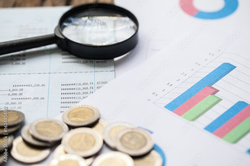 coins on bank account passbook and business chart coins on bank account passbook and business chart