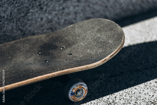 Skateboard on skate park at sunset.