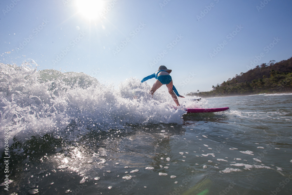 Kids learning to surf at a surf school in Santa Teresa, Costa Rica