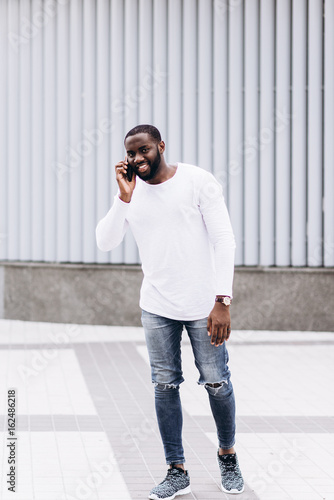Handsome Afro American man wearing casual clothes in modern city